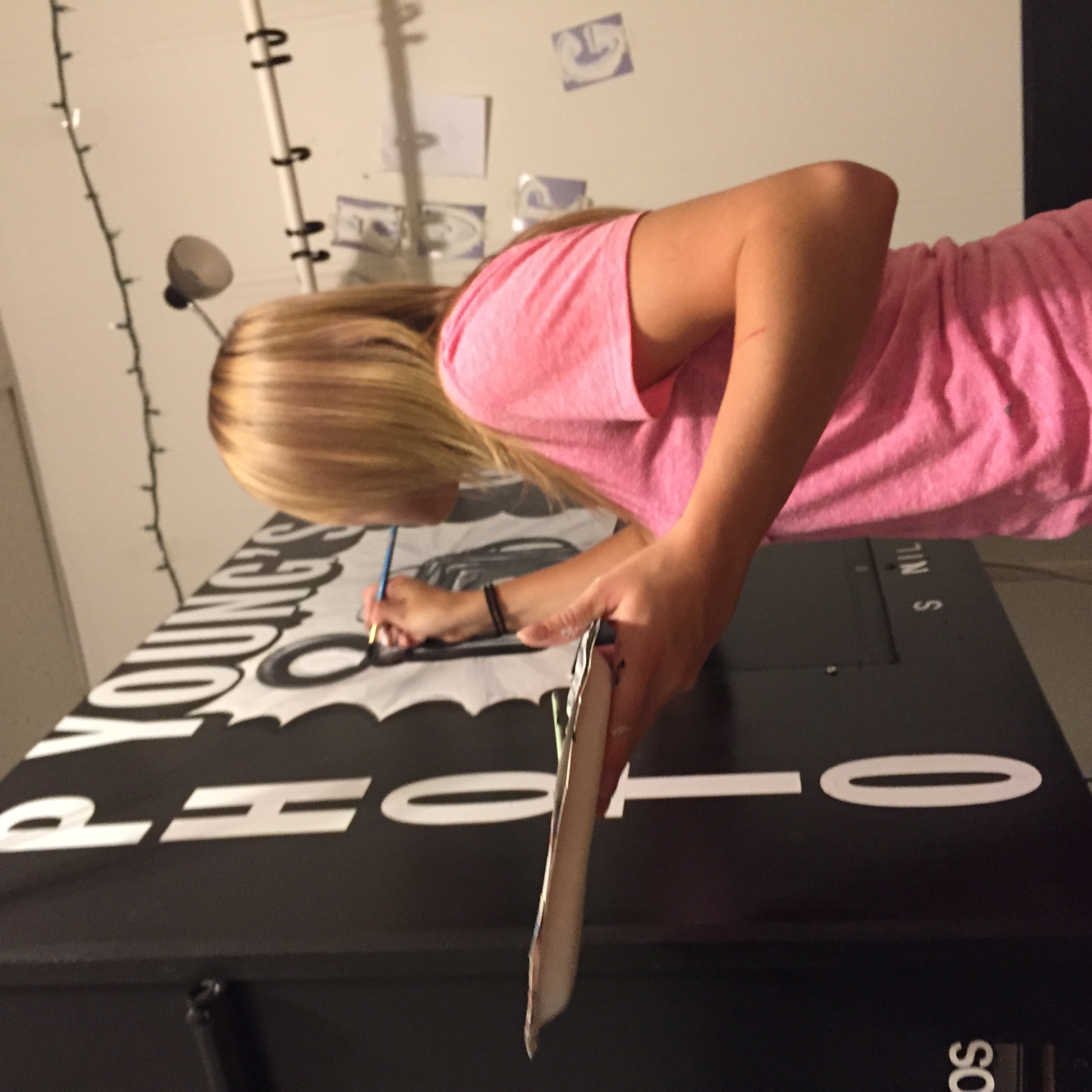 Bekah hand-painting the Young's Photobooth logo onto a booth